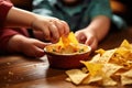 kids hand reaching for a nachos chip