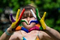 Kids hands in color paints make a heart shape, focus on hands Royalty Free Stock Photo