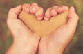 Kids hands in the form of heart with sand Royalty Free Stock Photo