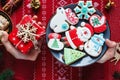 Kids hands with gift on red background. Holidays and celebration concept, greeting card mockup, festive decoration. Christmas