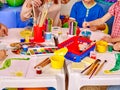 Kids hands holding colored paper and glue on table Royalty Free Stock Photo