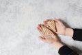 Kids hands holding couple of ginger bread heart cookies with white icing. Valentine or Mothers day holiday day