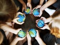 Kids hands holding cupping globe balls together Royalty Free Stock Photo