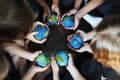 Kids hands holding cupping globe balls together Royalty Free Stock Photo