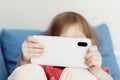 Kids hands holding white smartphone. Close up image