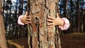 Kids hands hugging tree trunk Royalty Free Stock Photo