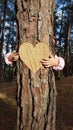 Kids hands hugging tree trunk Royalty Free Stock Photo