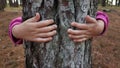 Kids hands hugging tree trunk Royalty Free Stock Photo