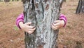 Kids hands hugging tree trunk Royalty Free Stock Photo