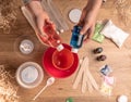 Kids hands making slime toy at home