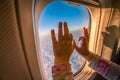 Kids hands on the plane window Royalty Free Stock Photo
