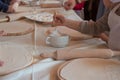 Kids hands in uniform preparing dough for pizza or pastry with rolling pins Royalty Free Stock Photo