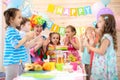 Kids are happy after they have blowed candles out on birthday party