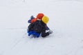 Kids have fun sledding with snow slides Royalty Free Stock Photo