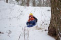 Kids have fun sledding with snow slides Royalty Free Stock Photo