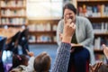 Kids have many questions that fuel their curious minds. an elementary school boy raising his hand to his teacher in the Royalty Free Stock Photo