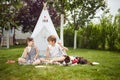 Kids have a meal in camp in a backyard