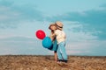 Kids having fun in field against blue sky background. Love story. Happy children girl and boy hug on meadow in summer in