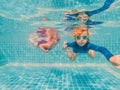 Kids having fun playing underwater in swimming pool on summer vacation Royalty Free Stock Photo