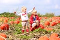 Kids having fun on pumpkin field Royalty Free Stock Photo