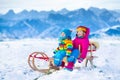 Kids having fun on a sleigh ride in snow Royalty Free Stock Photo