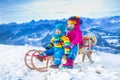 Kids having fun on a sleigh ride in snow Royalty Free Stock Photo