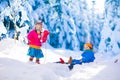 Kids having fun on a sleigh ride in snow Royalty Free Stock Photo