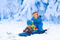 Kids having fun on a sleigh ride in winter Royalty Free Stock Photo