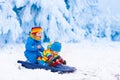 Kids having fun on a sleigh ride in winter Royalty Free Stock Photo