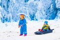 Kids having fun on a sleigh ride in winter Royalty Free Stock Photo