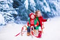 Kids having fun on a sleigh ride in winter Royalty Free Stock Photo