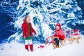 Kids having fun on a sleigh ride in winter Royalty Free Stock Photo