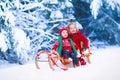 Kids having fun on a sleigh ride in winter Royalty Free Stock Photo