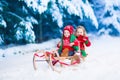 Kids having fun on a sleigh ride in winter Royalty Free Stock Photo