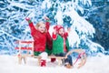 Kids having fun on a sleigh ride in winter Royalty Free Stock Photo