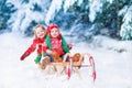 Kids having fun on a sleigh ride in winter Royalty Free Stock Photo