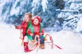 Kids having fun on a sleigh ride in winter Royalty Free Stock Photo