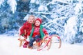 Kids having fun on a sleigh ride in winter Royalty Free Stock Photo