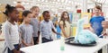 Kids having fun watching an experiment at a science centre