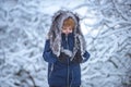 Kids having fun in white snow field against snowy trees. Kids winter portrait. Child playing in the snowy field in Royalty Free Stock Photo