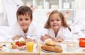 Kids having a healthy breakfast in bed Royalty Free Stock Photo