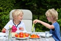 Kids having healthy picnic outdoors