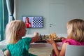 Kids having online chess lesson, e-education, little girls on distant learning