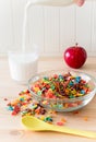 Kids healthy quick breakfast. Colorful rice cereal, flowing milk