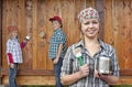 Kids helping their mother painting the wood shed