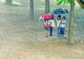 Kids hiding under umbrella