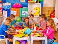 Kids holding colored paper and glue on table in Royalty Free Stock Photo