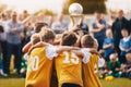 Kids Holding Golden Cup. Boys Winning Soccer Championship