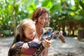 Kids hold python snake at zoo. Child and reptile