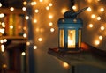 Kids holds Christmas lantern in hands on lights bokeh background. New year celebration concept